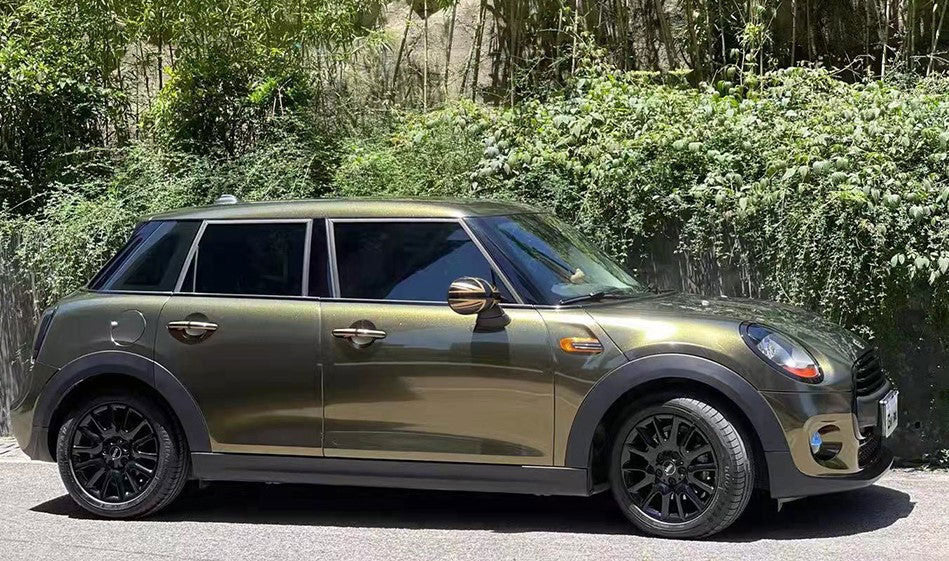 masina auriu inchis parcata pe o parte a strazii